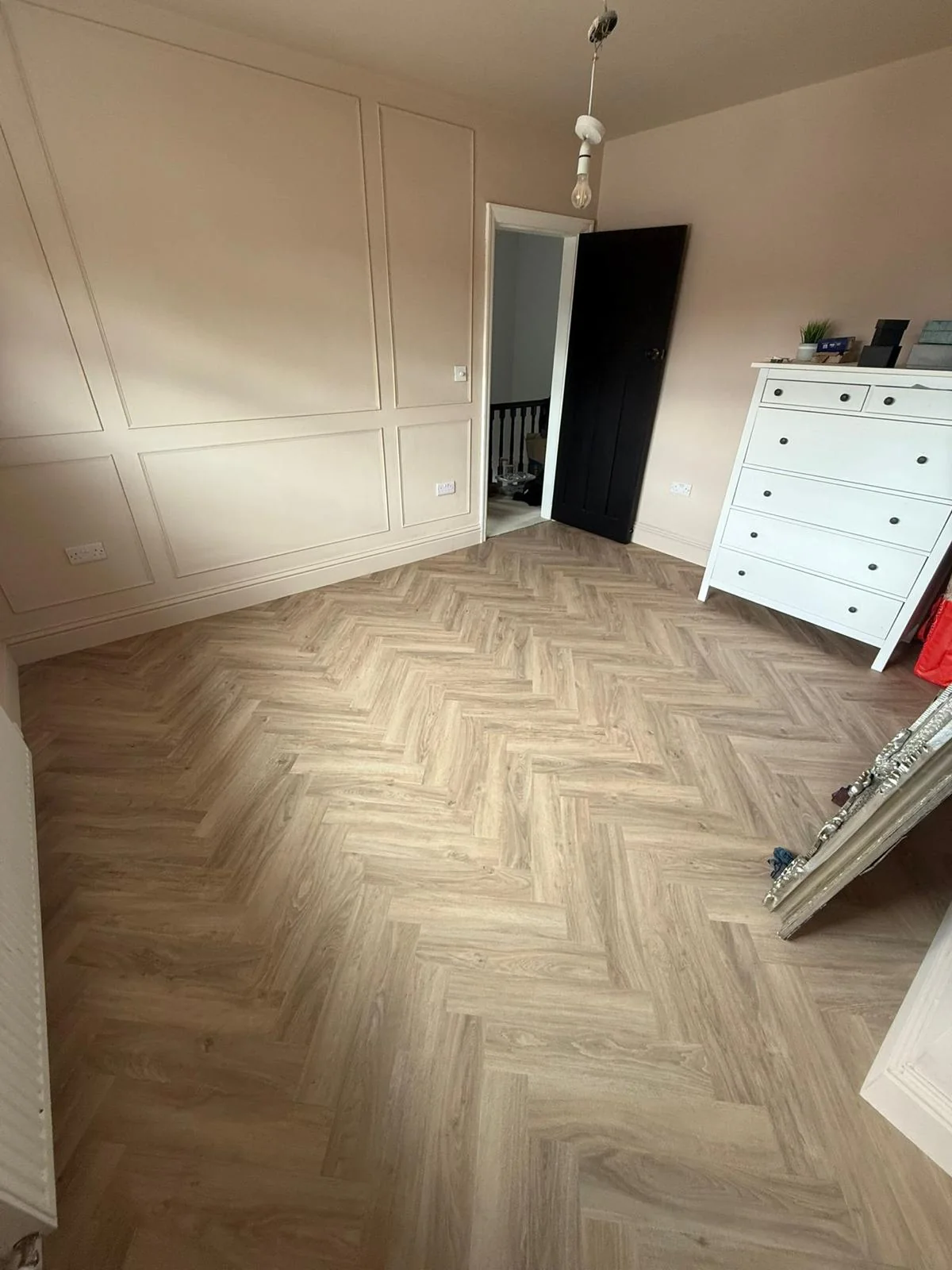 Herringbone flooring in a bedroom