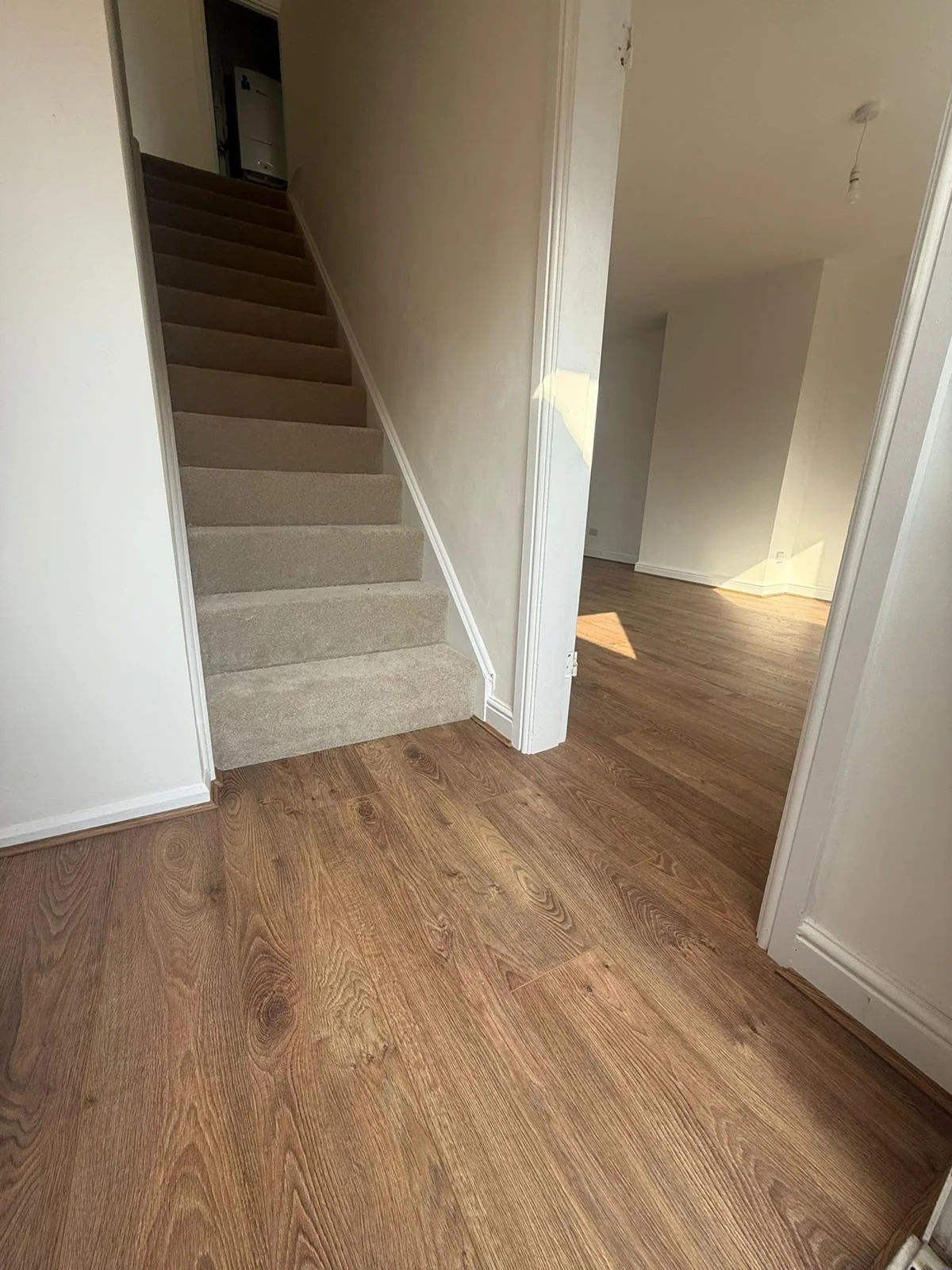 Wood-effect hallway flooring with carpeted stairs