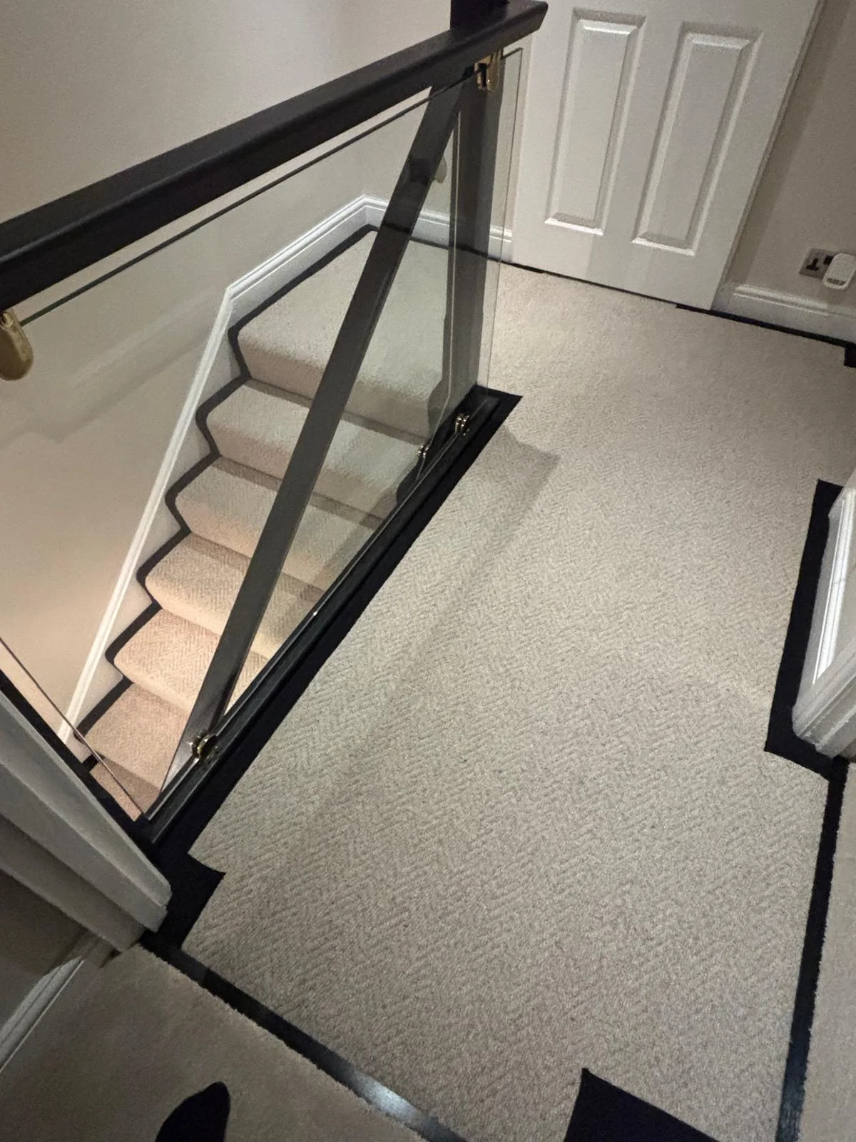 Carpeted landing with a contrasting border