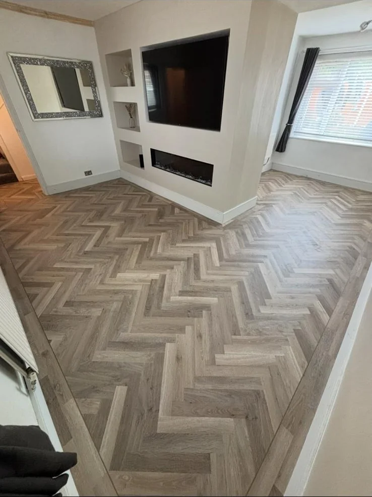 Herringbone flooring around a media wall
