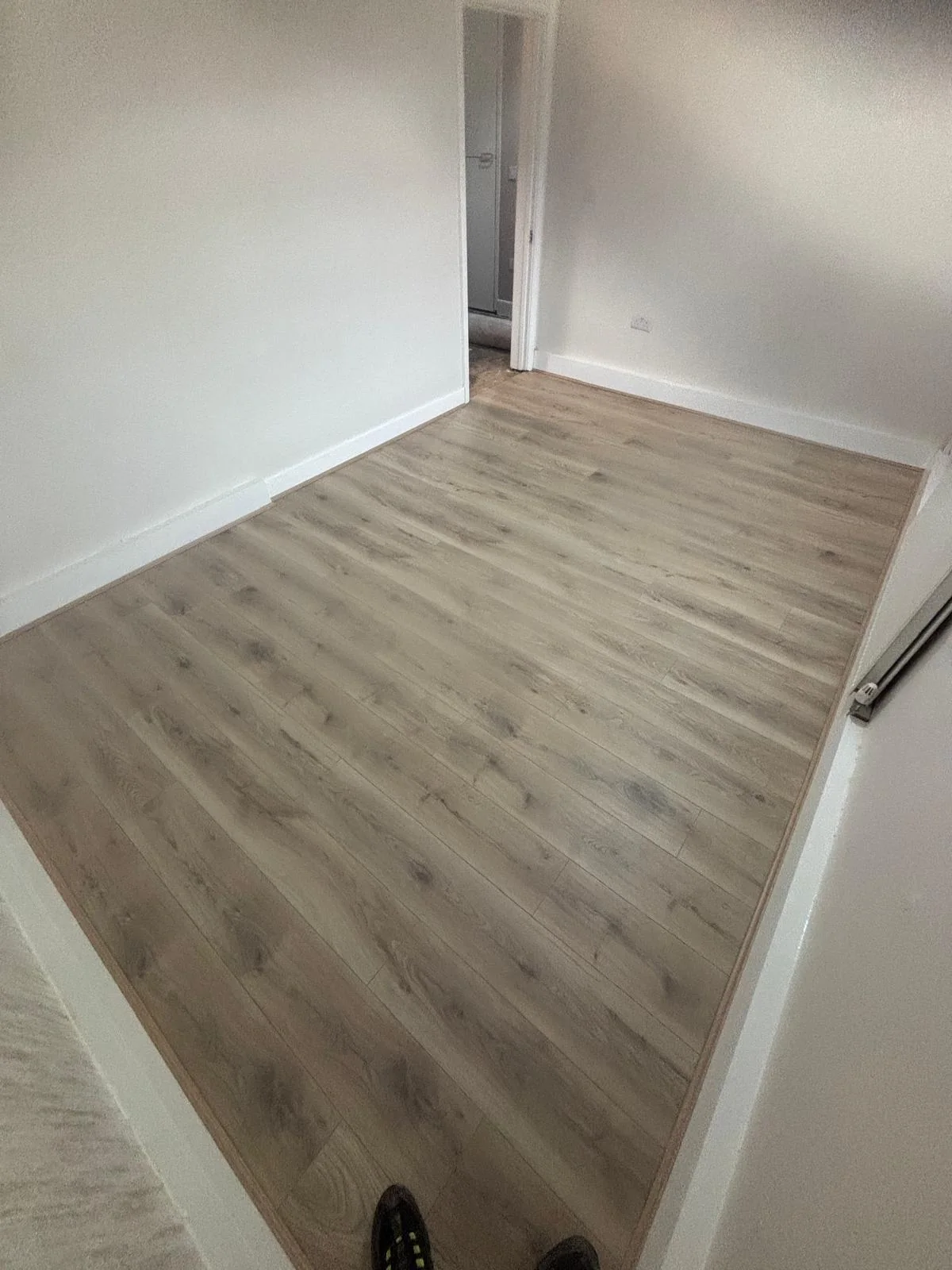 Pale wood-effect flooring in a bedroom
