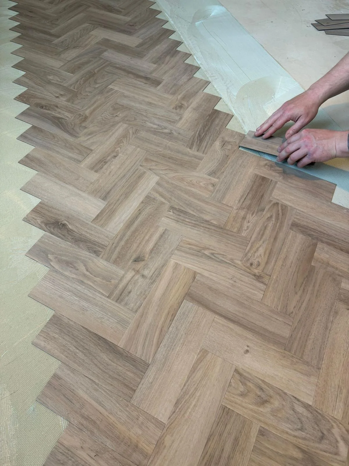 Herringbone flooring being laid